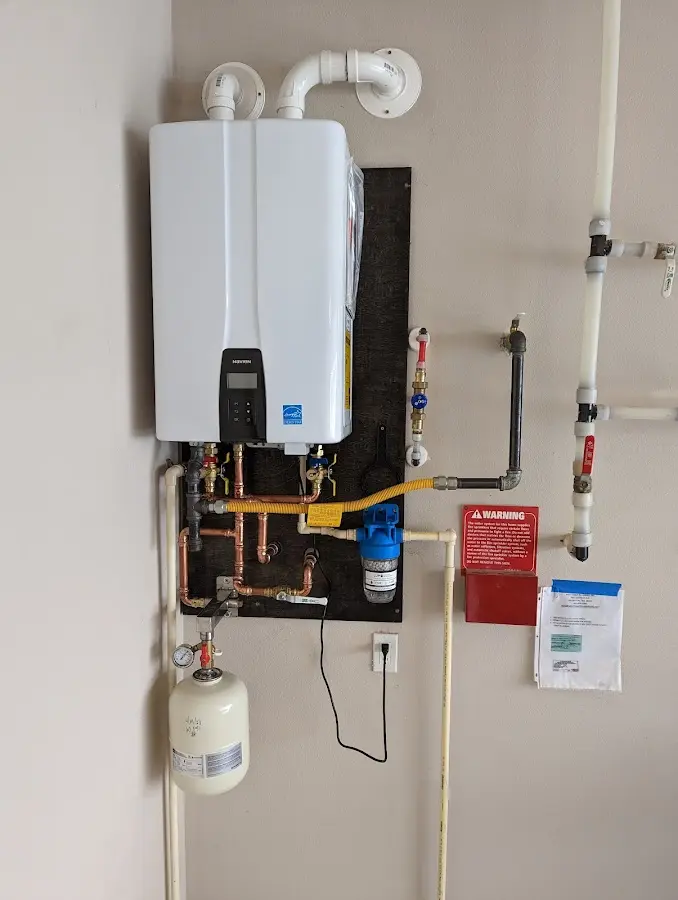 Professional plumber installing copper piping in a Herriman home